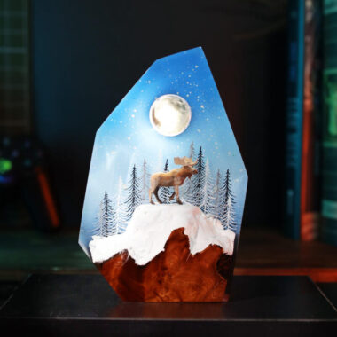 Reindeer in a winter forest lamp